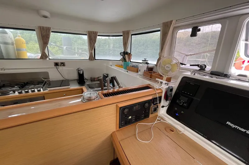 Tikiaora Yacht Photos Pics Interior of 2008 Lagoon 500 yacht with kitchen and navigation equipment.