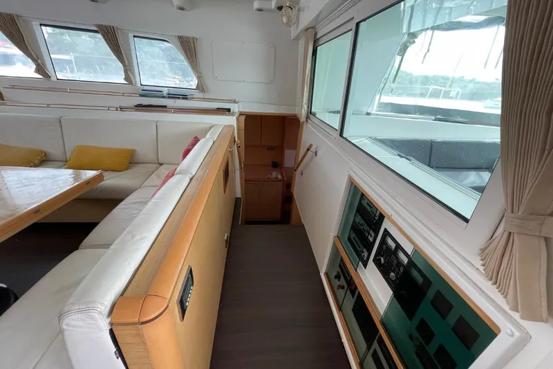 Tikiaora Yacht Photos Pics Interior of 2008 Lagoon 500 yacht with seating area and control panels.