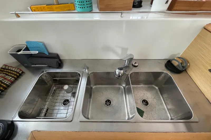 Tikiaora Yacht Photos Pics Stainless steel triple sink in a 2008 Lagoon 500 yacht kitchen.