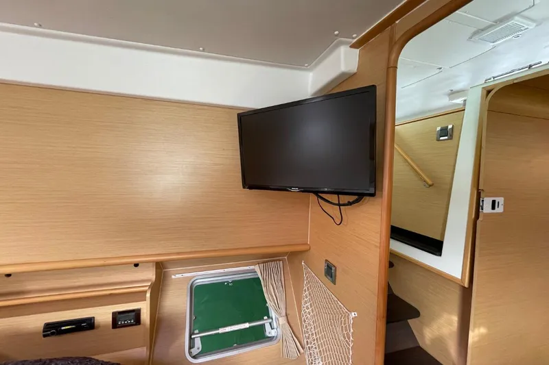 Tikiaora Yacht Photos Pics Interior of 2008 Lagoon 500 yacht with mounted TV and wooden paneling.