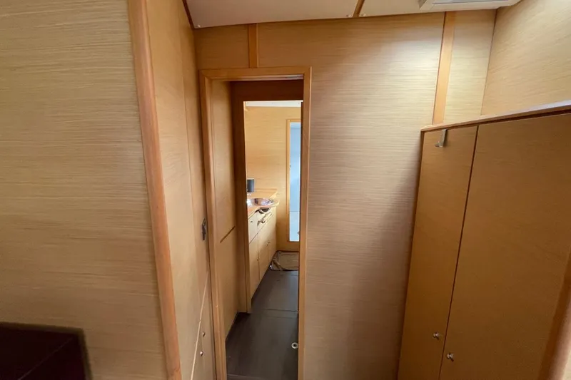 Tikiaora Yacht Photos Pics Interior hallway of 2008 Lagoon 500 yacht with wooden paneling and cabinetry.