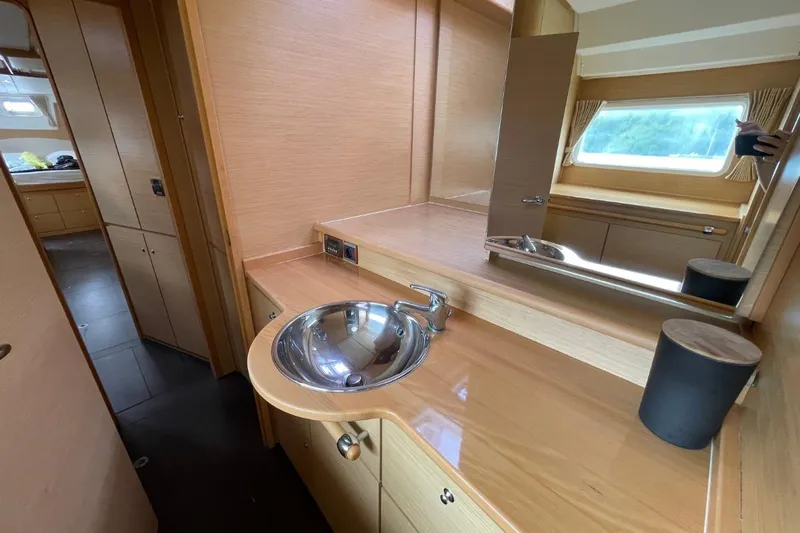Tikiaora Yacht Photos Pics Interior of 2008 Lagoon 500 yacht featuring a sleek bathroom with wooden cabinetry.