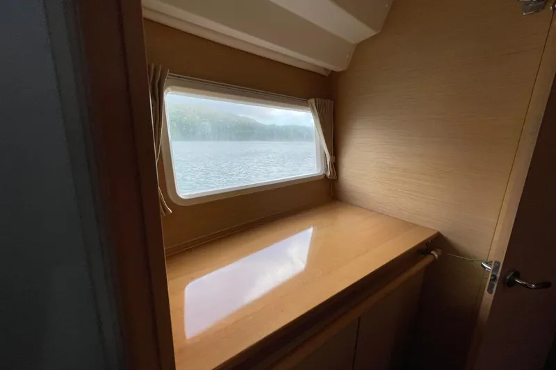 Tikiaora Yacht Photos Pics Interior of 2008 Lagoon 500 yacht with window view of water.
