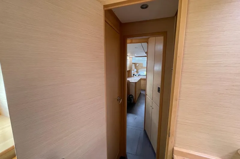 Tikiaora Yacht Photos Pics Interior hallway of a 2008 Lagoon 500 yacht, featuring wooden paneling and modern design.