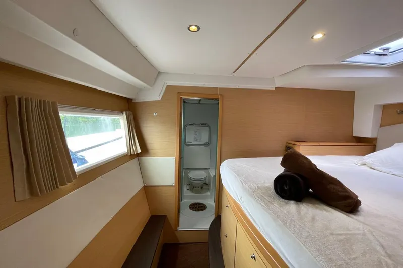 Tikiaora Yacht Photos Pics Luxurious cabin interior of 2008 Lagoon 500 yacht with bed and ensuite bathroom.