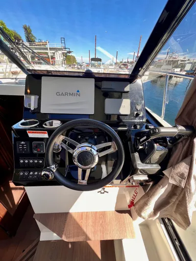  Yacht Photos Pics 2019 Jeanneau NC 1095 helm with Garmin navigation system, docked at marina.