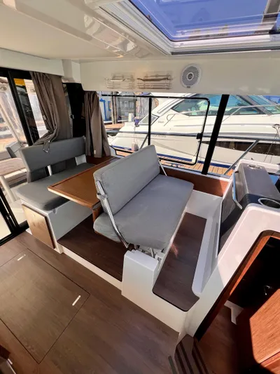  Yacht Photos Pics Interior of 2019 Jeanneau NC 1095 boat with seating and table.