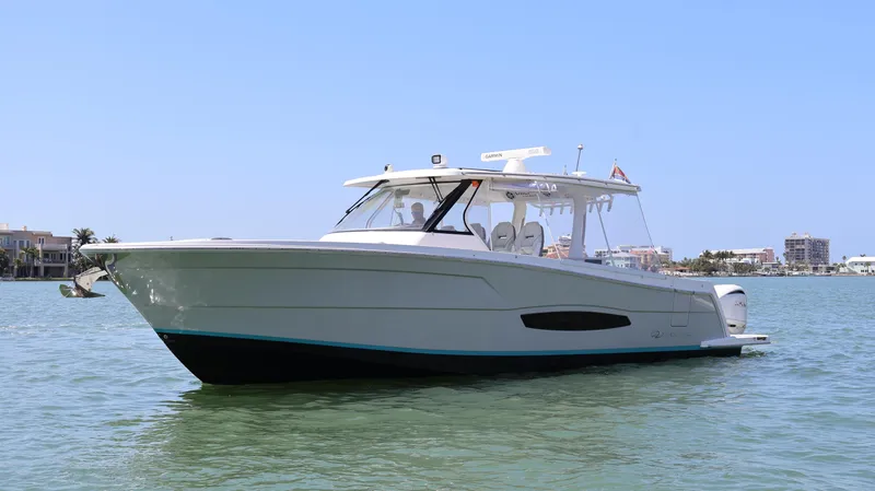  Yacht Photos Pics 2022 Regal 38 SAV boat on calm water, clear sky background.