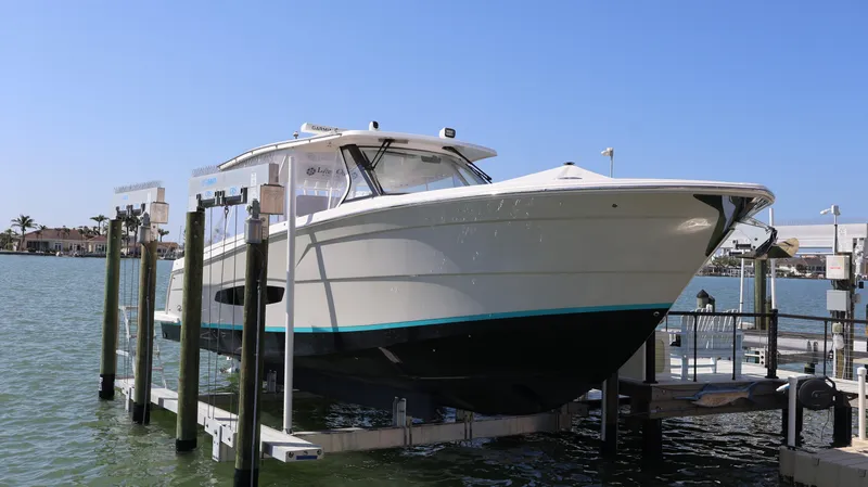  Yacht Photos Pics 2022 Regal 38 SAV boat on lift, docked by waterfront.