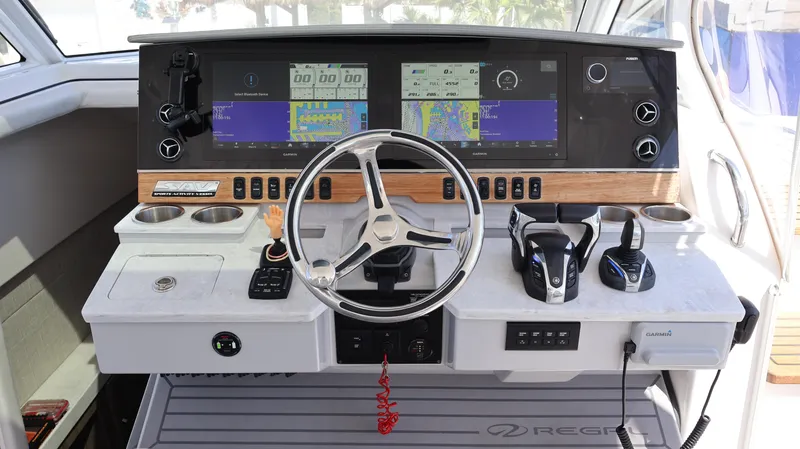  Yacht Photos Pics 2022 Regal 38 SAV boat dashboard with steering wheel and navigation screens.