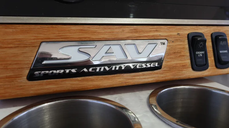  Yacht Photos Pics 2022 Regal 38 SAV Sports Activity Vessel logo on wooden panel with cup holders.
