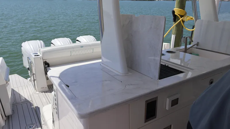  Yacht Photos Pics 2022 Regal 38 SAV boat with sleek deck and powerful outboard engines.