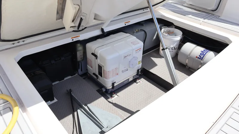  Yacht Photos Pics 2022 Regal 38 SAV engine compartment with generator and storage items.