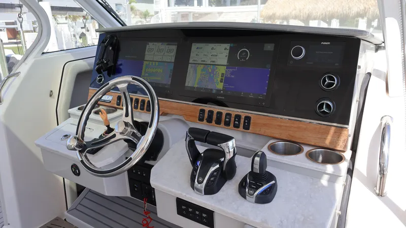  Yacht Photos Pics Cockpit of 2022 Regal 38 SAV boat with modern navigation controls and steering wheel.