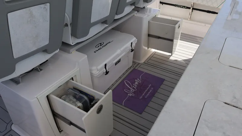  Yacht Photos Pics 2022 Regal 38 SAV boat interior with storage compartments and cooler.