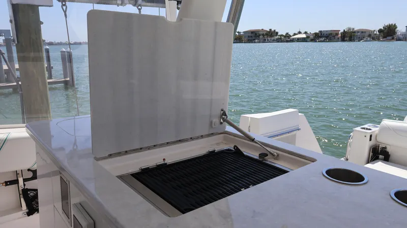  Yacht Photos Pics 2022 Regal 38 SAV boat with outdoor grill and ocean view.