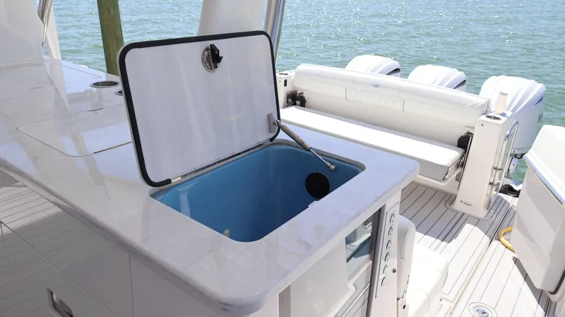  Yacht Photos Pics 2022 Regal 38 SAV boat interior with open storage compartment and seating area.