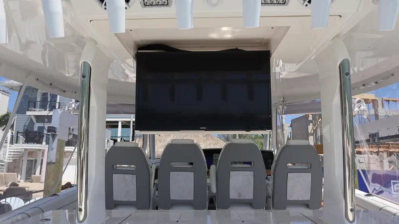  Yacht Photos Pics 2022 Regal 38 SAV boat interior with seating and mounted screen.
