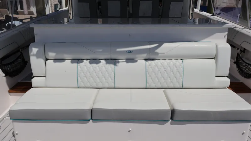  Yacht Photos Pics 2022 Regal 38 SAV boat with white cushioned seating and diamond stitching.
