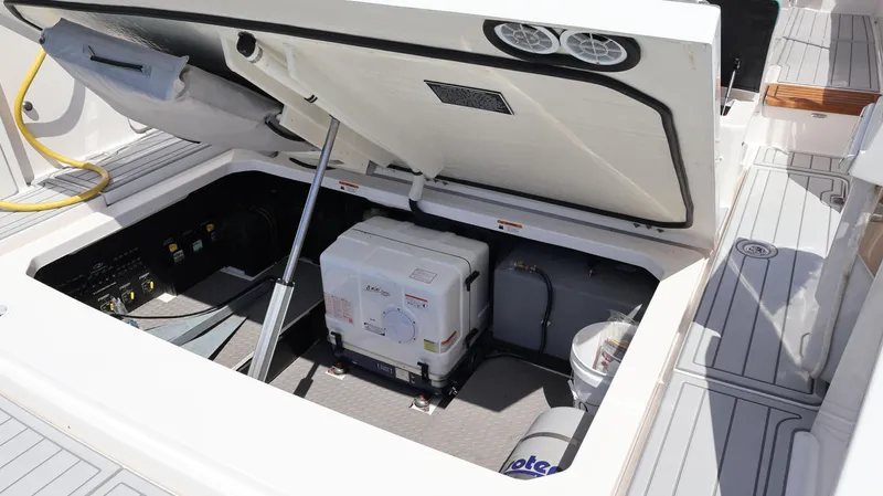  Yacht Photos Pics Open engine compartment of 2022 Regal 38 SAV boat, showcasing internal components.
