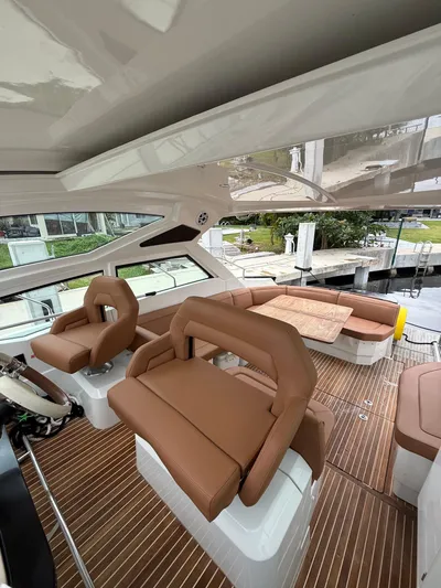Tis The Seasun Yacht Photos Pics 2017 Beneteau Gran Turismo 40 yacht interior with brown seating and wood flooring.