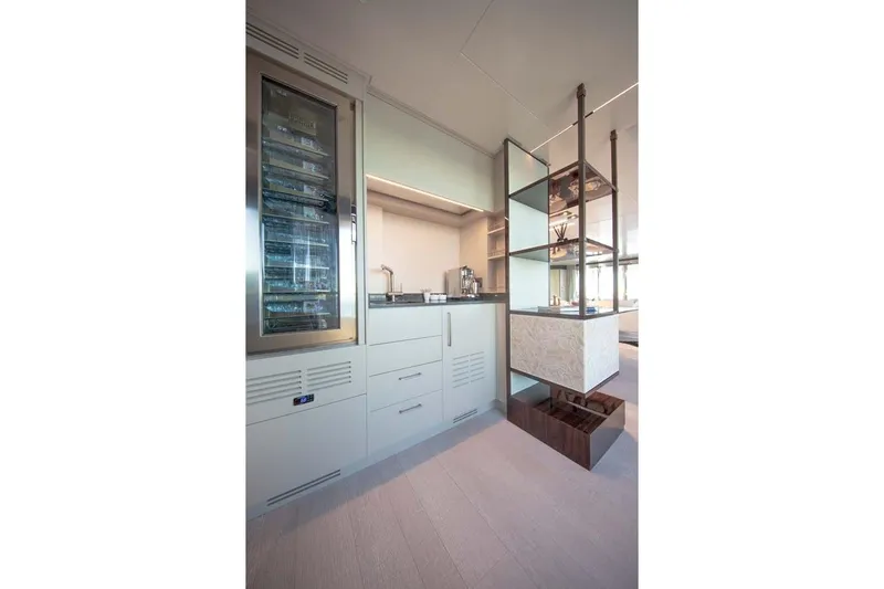 Oceanic 143 Yacht Photos Pics Modern kitchen interior on 2023 Canados Expedition Yacht, featuring sleek cabinetry and wine cooler.