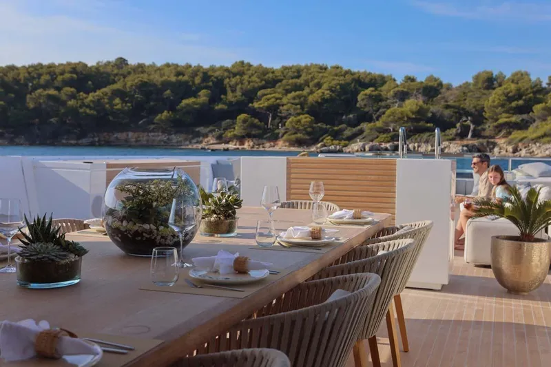 Oceanic 143 Yacht Photos Pics Luxurious 2023 Canados Expedition Yacht with elegant outdoor dining setup and scenic ocean view.