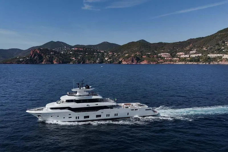 Oceanic 143 Yacht Photos Pics 2023 Canados Expedition Yacht cruising near scenic coastal landscape.