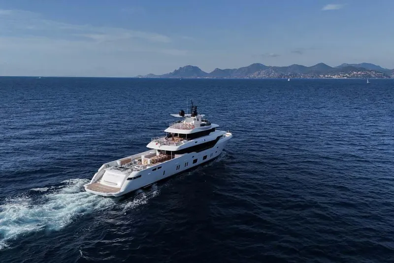 Oceanic 143 Yacht Photos Pics 2023 Canados Expedition Yacht cruising on open sea with scenic mountain backdrop.