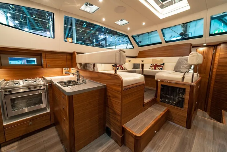 New Boat Built To Order Yacht Photos Pics Luxurious interior of 2025 Southerly 480 yacht with modern kitchen and seating area.