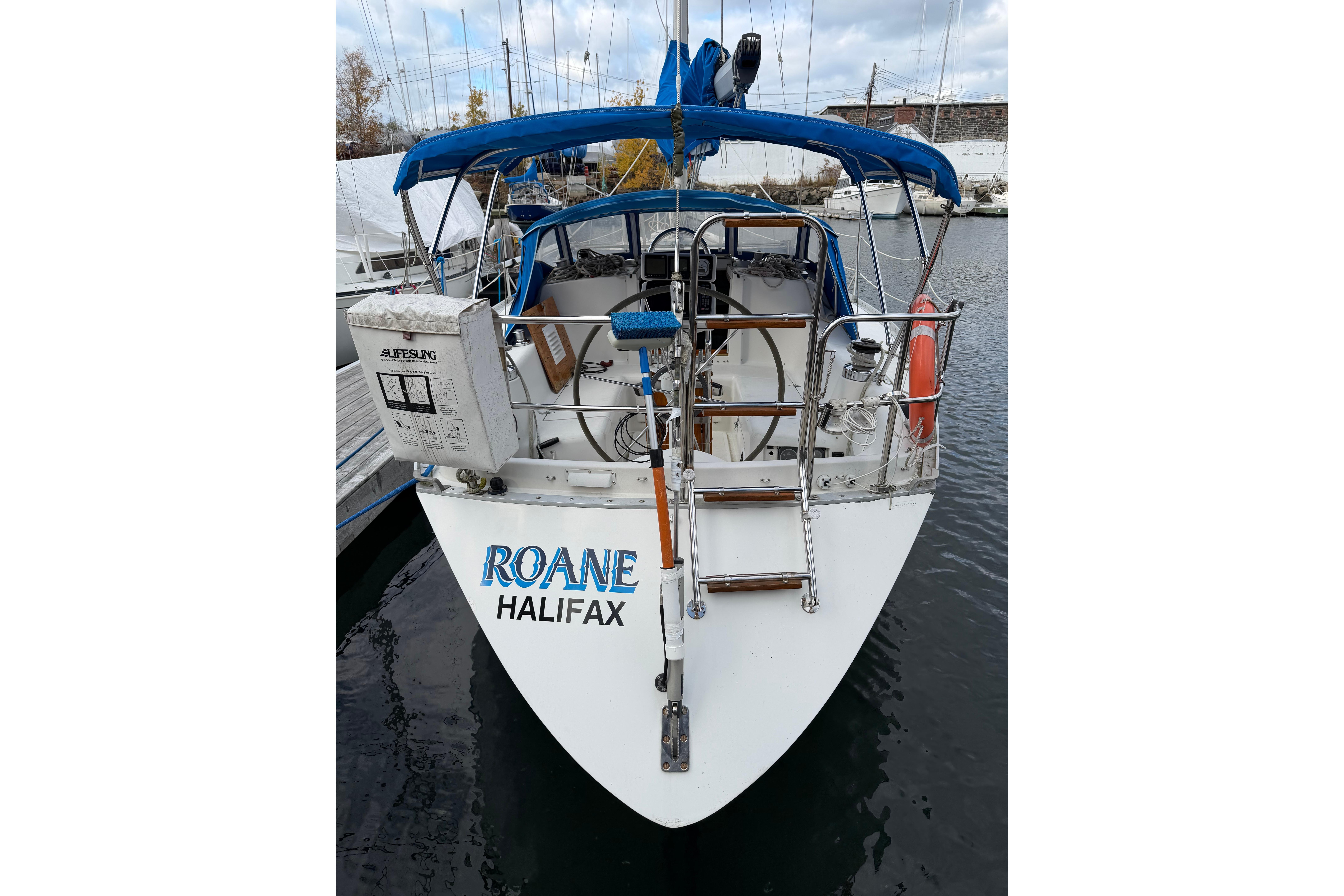 1985 CS 36 sailboat "Roane" docked in Halifax marina, featuring blue canopy.