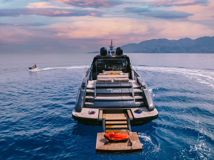  Yacht Photos Pics Luxury 2006 Riva 68 Ego yacht on serene ocean with scenic sunset backdrop.