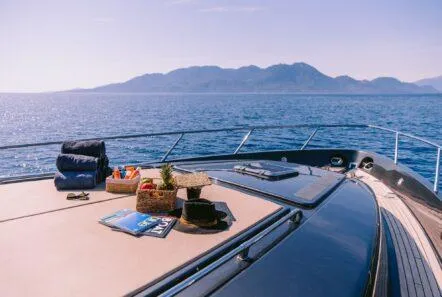  Yacht Photos Pics Luxurious 2006 Riva 68 Ego yacht deck with scenic ocean and mountain view.