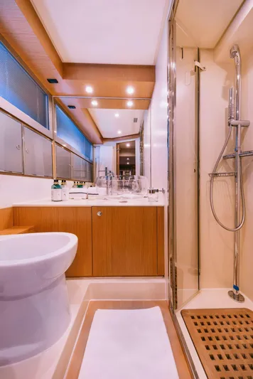  Yacht Photos Pics Luxurious bathroom in 2006 Riva 68 Ego yacht, featuring modern fixtures and elegant wood accents.