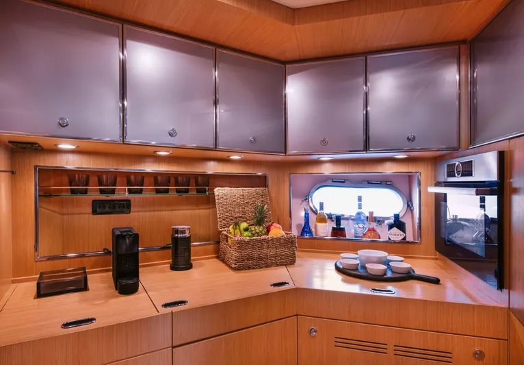  Yacht Photos Pics Luxurious kitchen interior of 2006 Riva 68 Ego yacht with modern appliances and wooden cabinetry.
