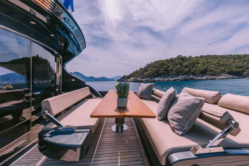  Yacht Photos Pics Luxurious 2006 Riva 68 Ego yacht deck with elegant seating, table, and scenic ocean view.