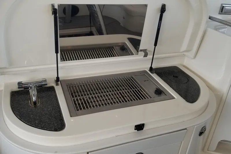  Yacht Photos Pics 2006 Cruisers Yachts 520 Express outdoor kitchen with sink and grill.