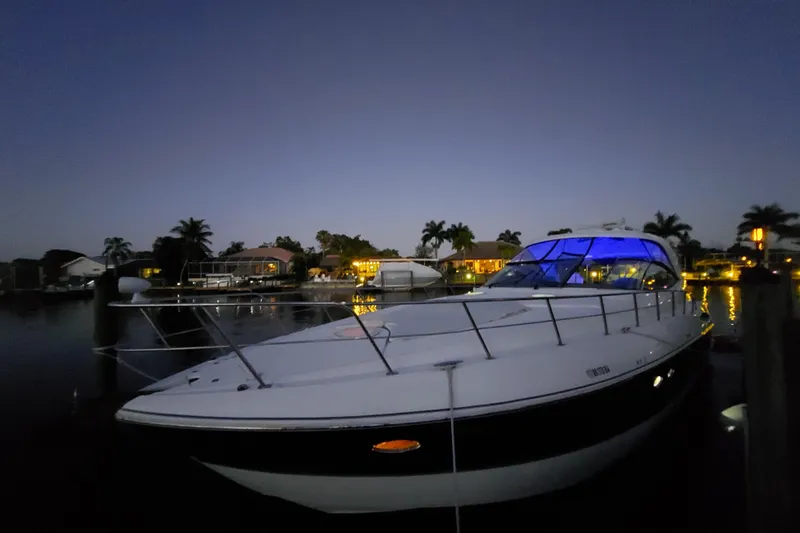  Yacht Photos Pics 2006 Cruisers Yachts 520 Express docked at twilight with blue cabin lights.