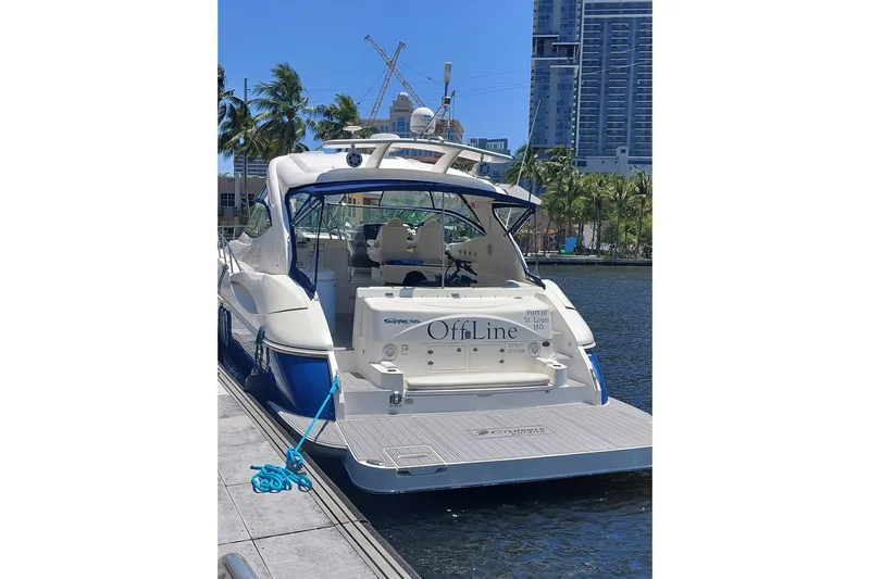  Yacht Photos Pics 2006 Cruisers Yachts 520 Express docked, with cityscape and palm trees in the background.