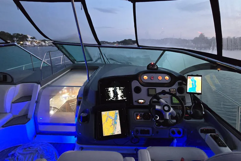  Yacht Photos Pics 2006 Cruisers Yachts 520 Express cockpit with illuminated controls and navigation screens at dusk.