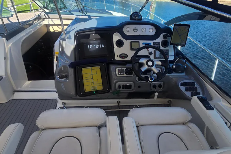  Yacht Photos Pics 2006 Cruisers Yachts 520 Express helm with navigation screens and steering wheel.