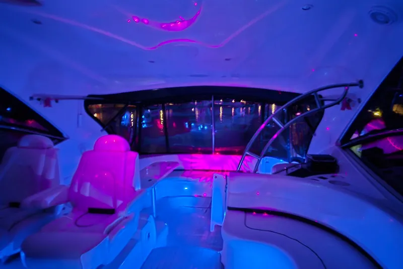  Yacht Photos Pics Interior of 2006 Cruisers Yachts 520 Express with vibrant pink and blue lighting.