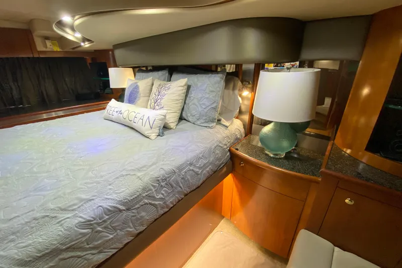  Yacht Photos Pics Luxurious 2006 Cruisers Yachts 520 Express bedroom with elegant bedding and ambient lighting.