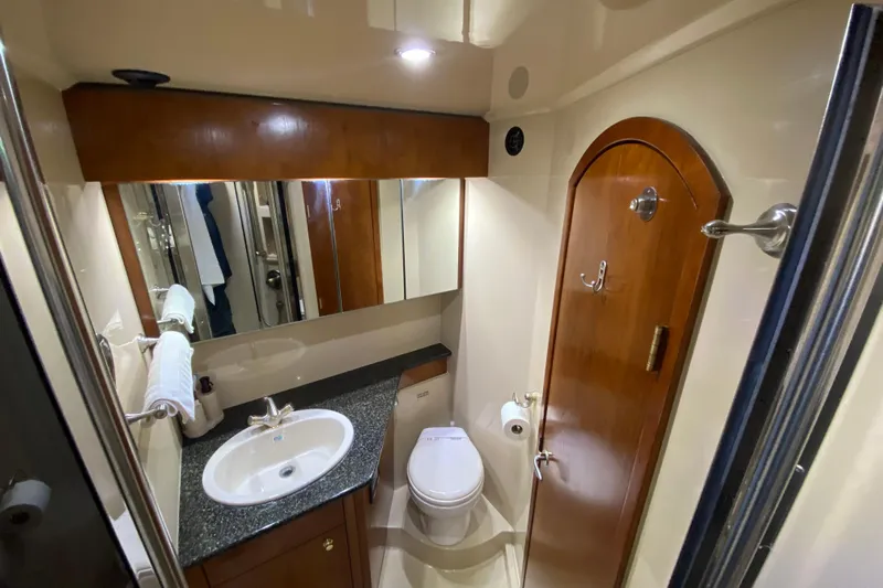  Yacht Photos Pics Luxurious bathroom in 2006 Cruisers Yachts 520 Express, featuring wood accents and modern fixtures.