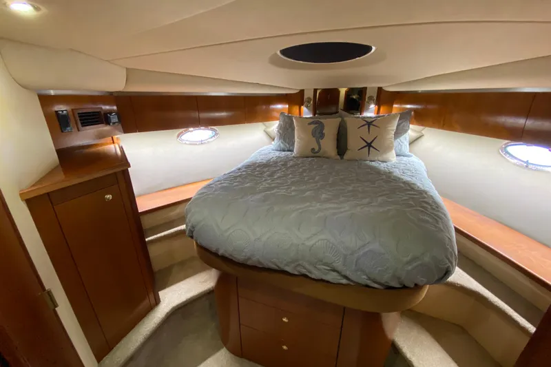  Yacht Photos Pics Luxurious cabin interior of 2006 Cruisers Yachts 520 Express with cozy bed and nautical decor.