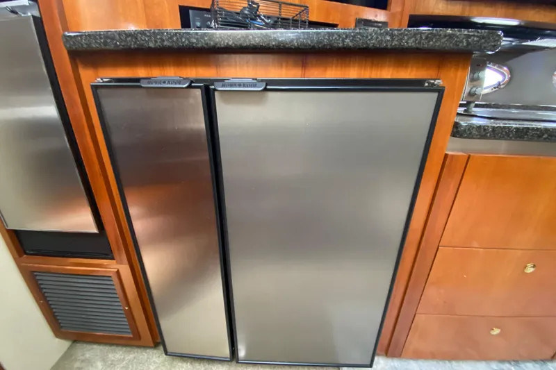  Yacht Photos Pics Stainless steel refrigerator in 2006 Cruisers Yachts 520 Express galley.