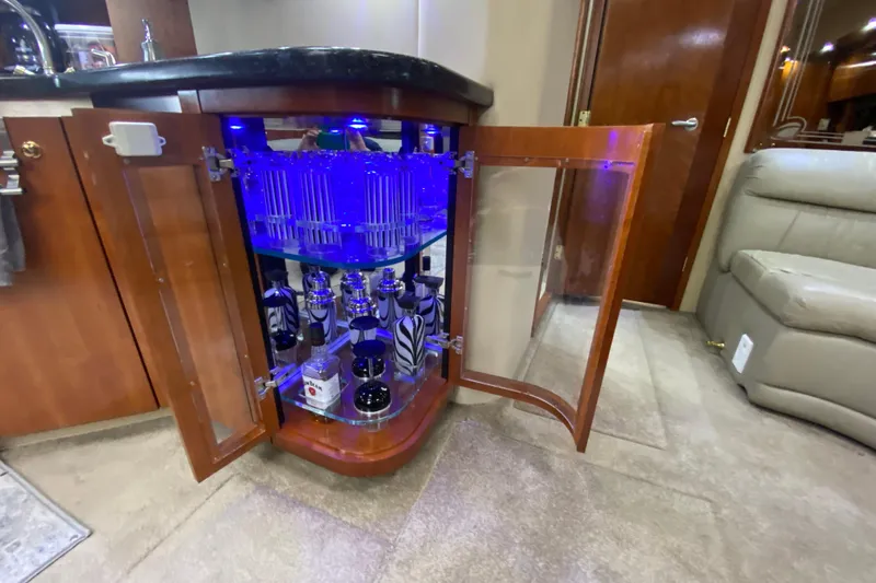  Yacht Photos Pics Luxurious 2006 Cruisers Yachts 520 Express interior with illuminated liquor cabinet.