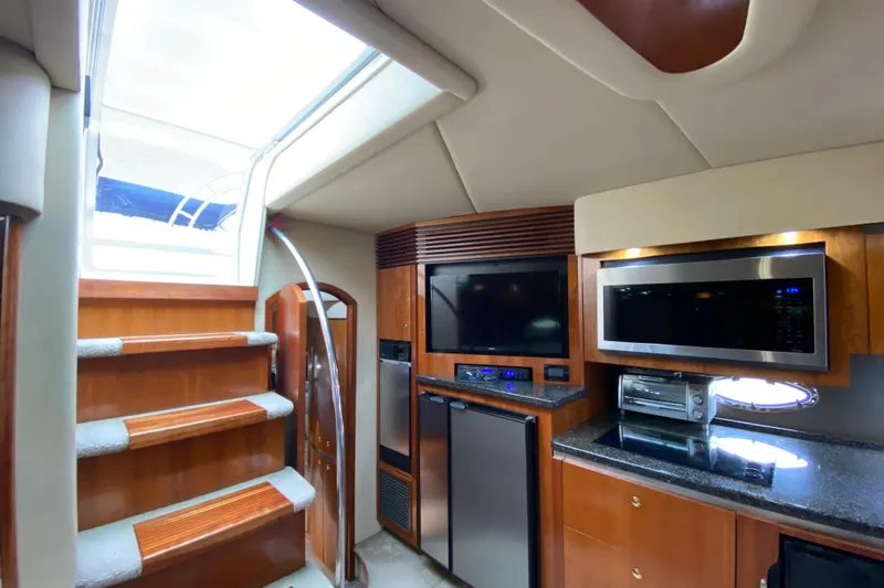  Yacht Photos Pics Luxurious interior of 2006 Cruisers Yachts 520 Express with modern kitchen amenities.