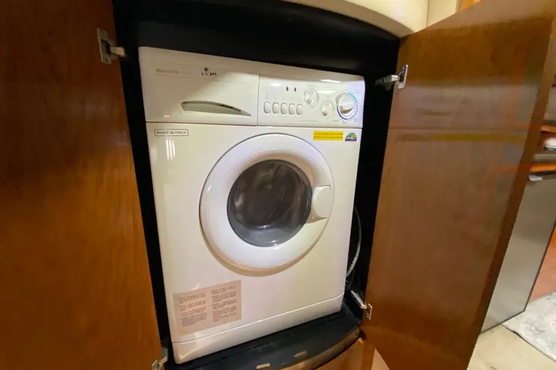  Yacht Photos Pics Front-loading washing machine in wooden cabinet on 2006 Cruisers Yachts 520 Express.