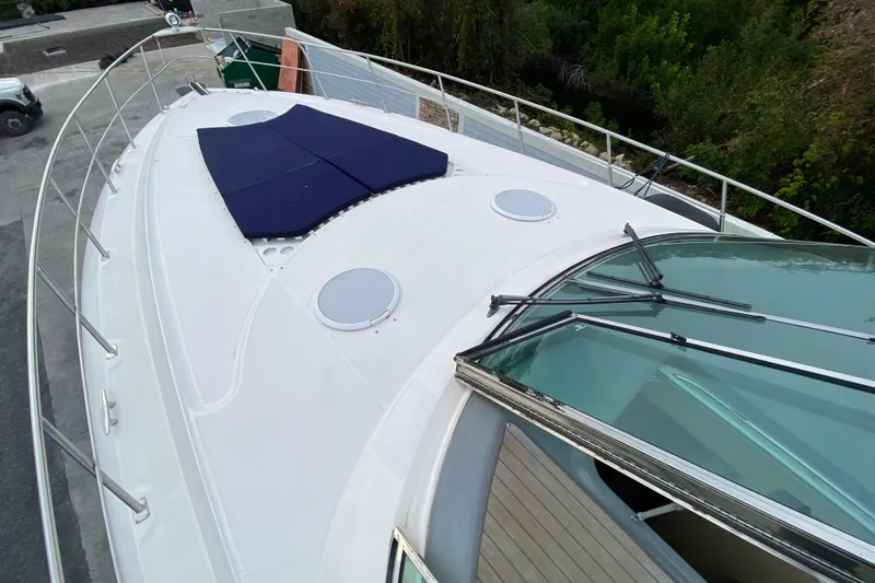  Yacht Photos Pics 2006 Cruisers Yachts 520 Express boat deck with sunpad and windshield.